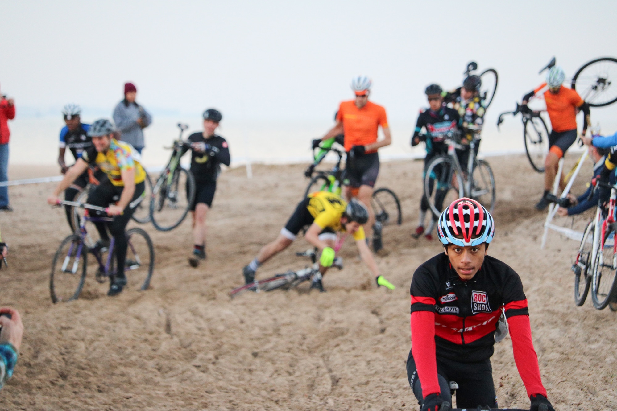 Group of cyclist riding through sand