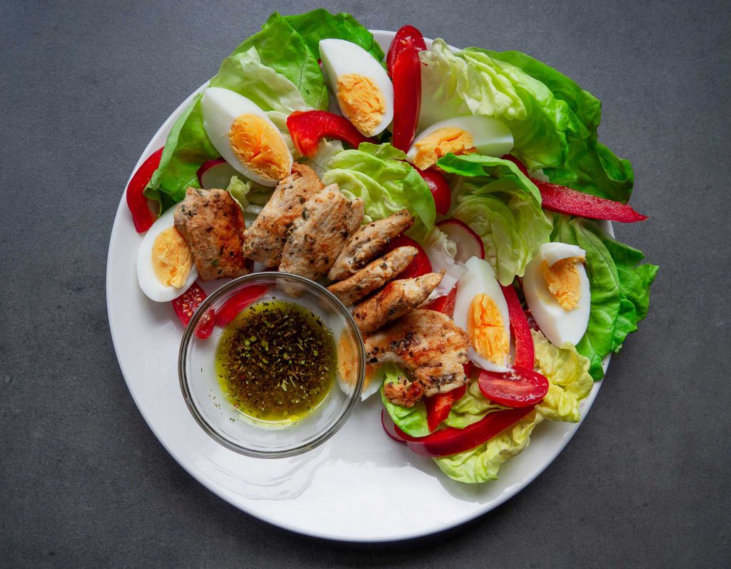 Salad with Grilled Chicken and Eggs preparation ready to eat